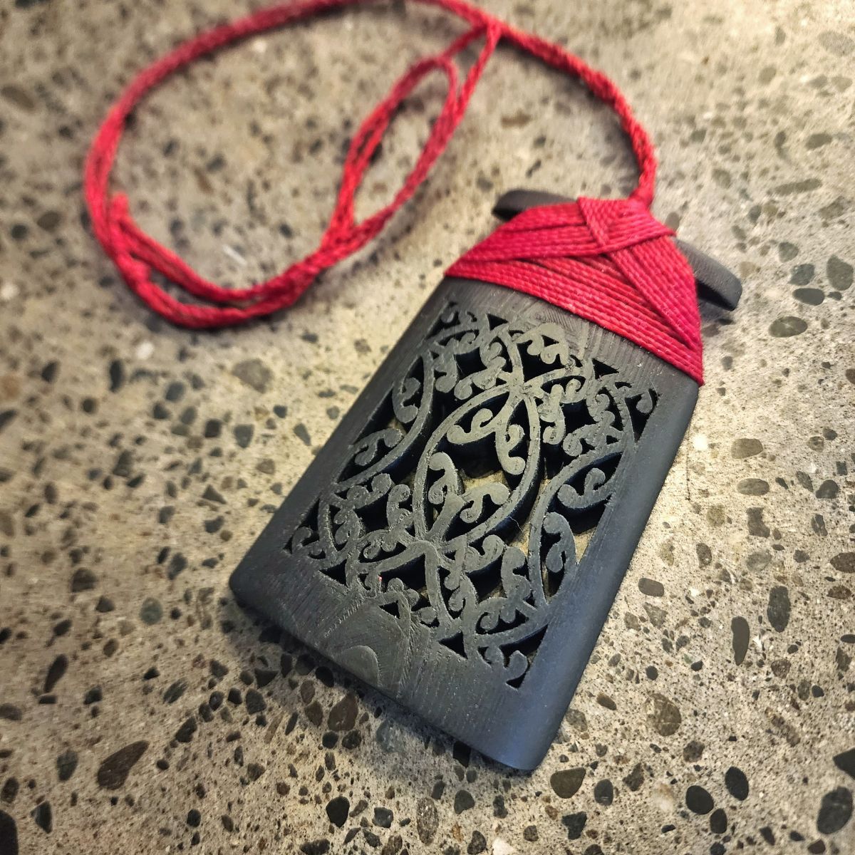 black ebony wood toki pendant with red binding and cord