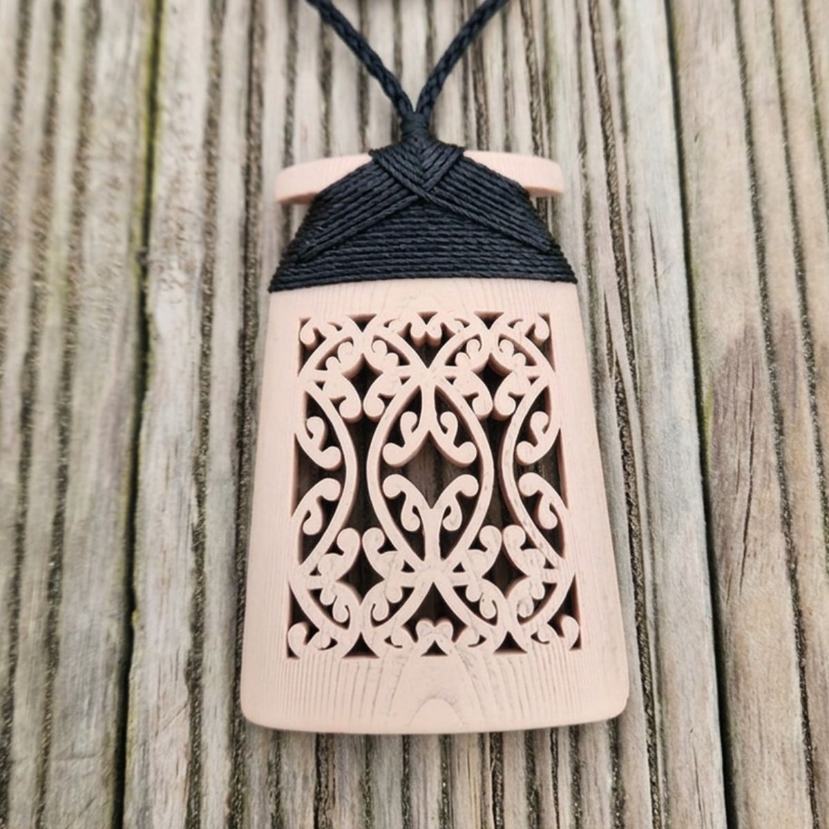 bone coloured toki necklace with black binding and cord