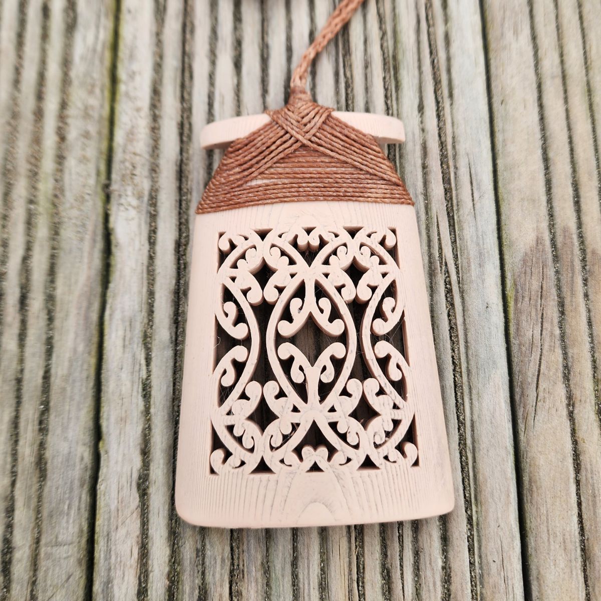 bone coloured toki necklace with cinnamon brown binding