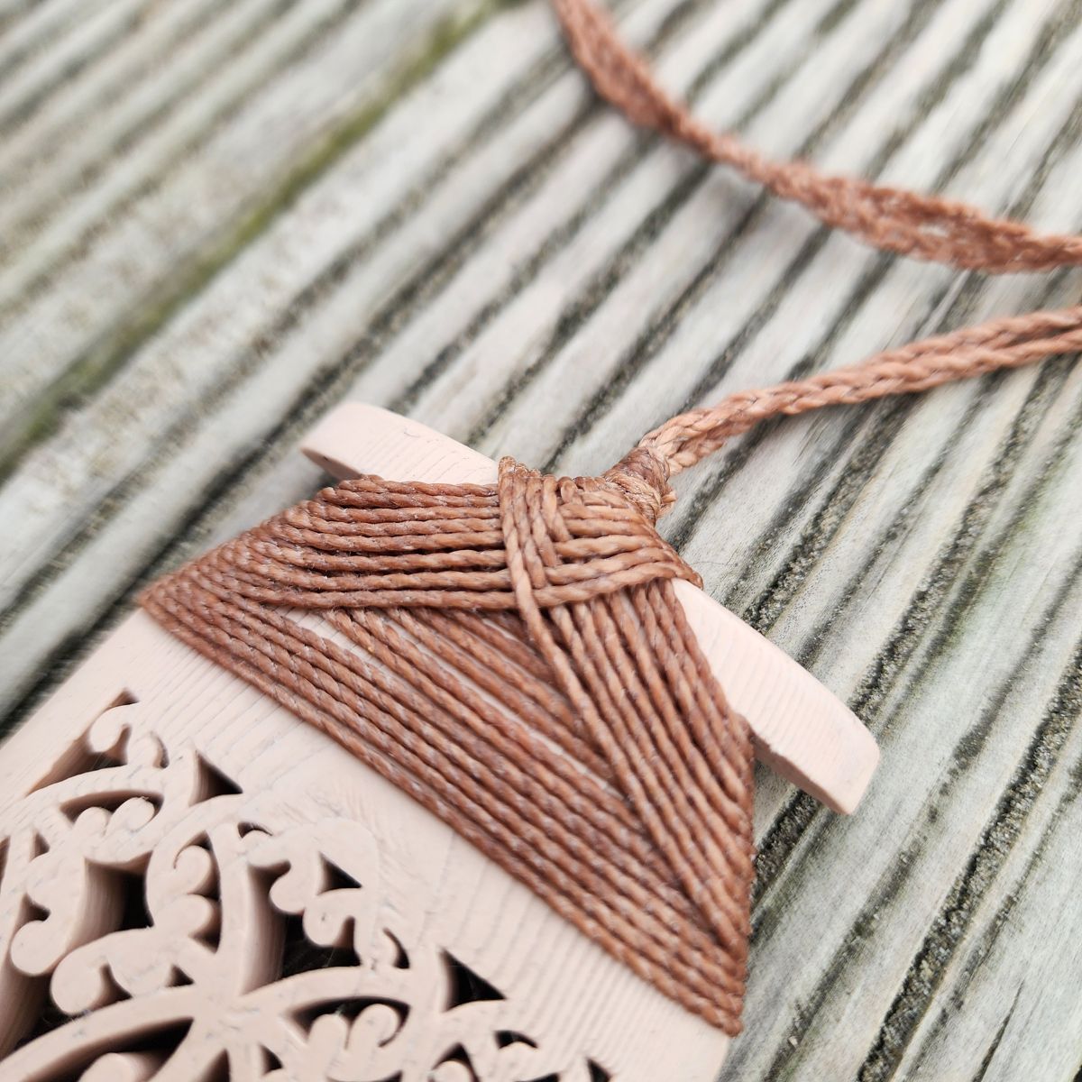 bone coloured 3d printed toki necklace with closeup of brown binding and cord