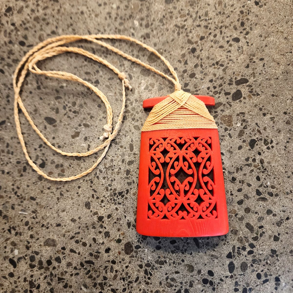 red coloured toki necklace with natural linen coloured binding and cord