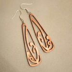 Closeup of the copper mangōpare toki earrings