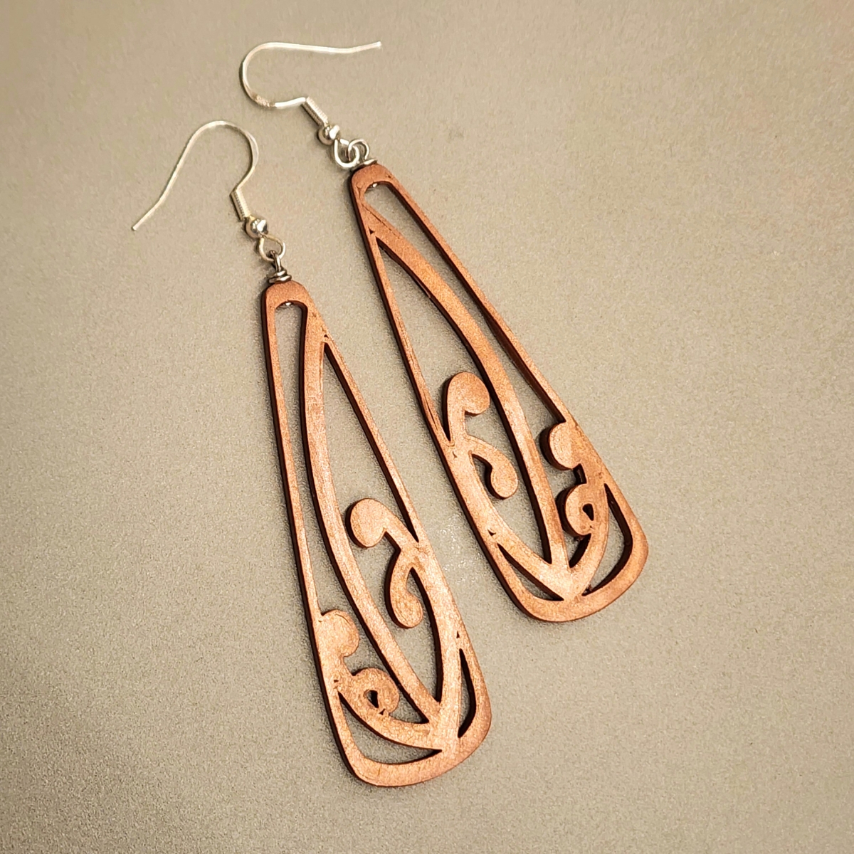 Closeup of the copper mangōpare toki earrings