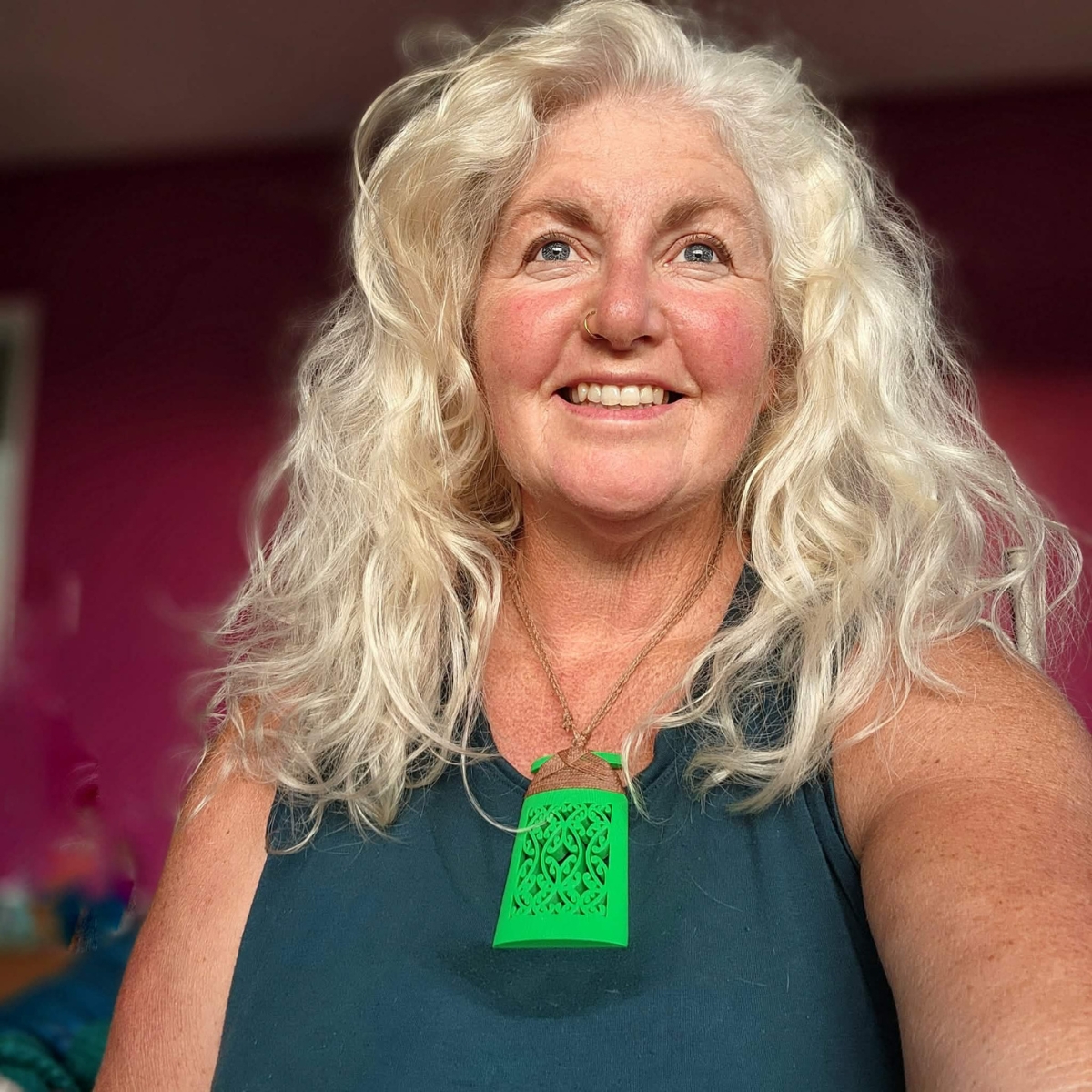 model with grey hair wearing a green mangōpare toki necklace
