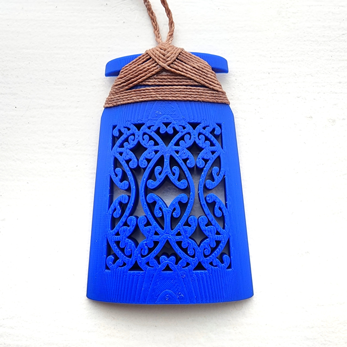 blue toki necklace with brown binding on white background