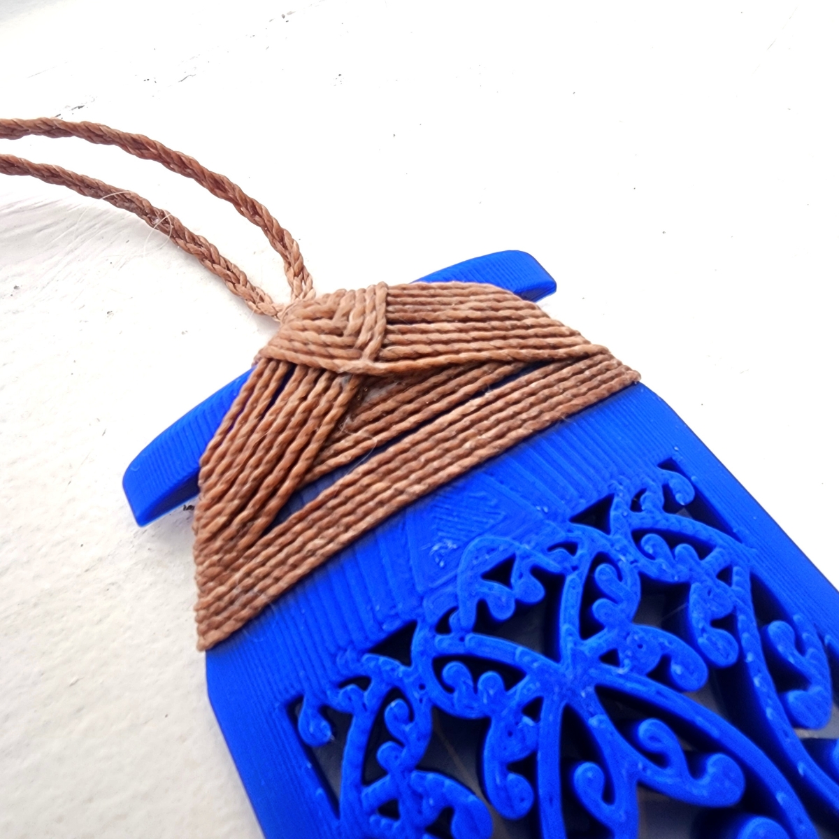 closeup of the traditional binding on blue toki necklace