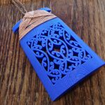 blue toki necklace sitting on a wooden background