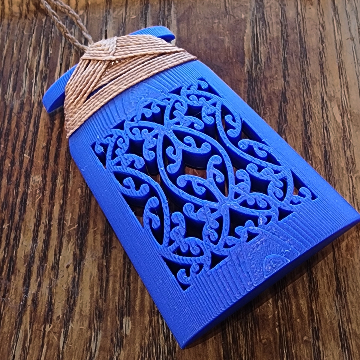 blue toki necklace sitting on a wooden background