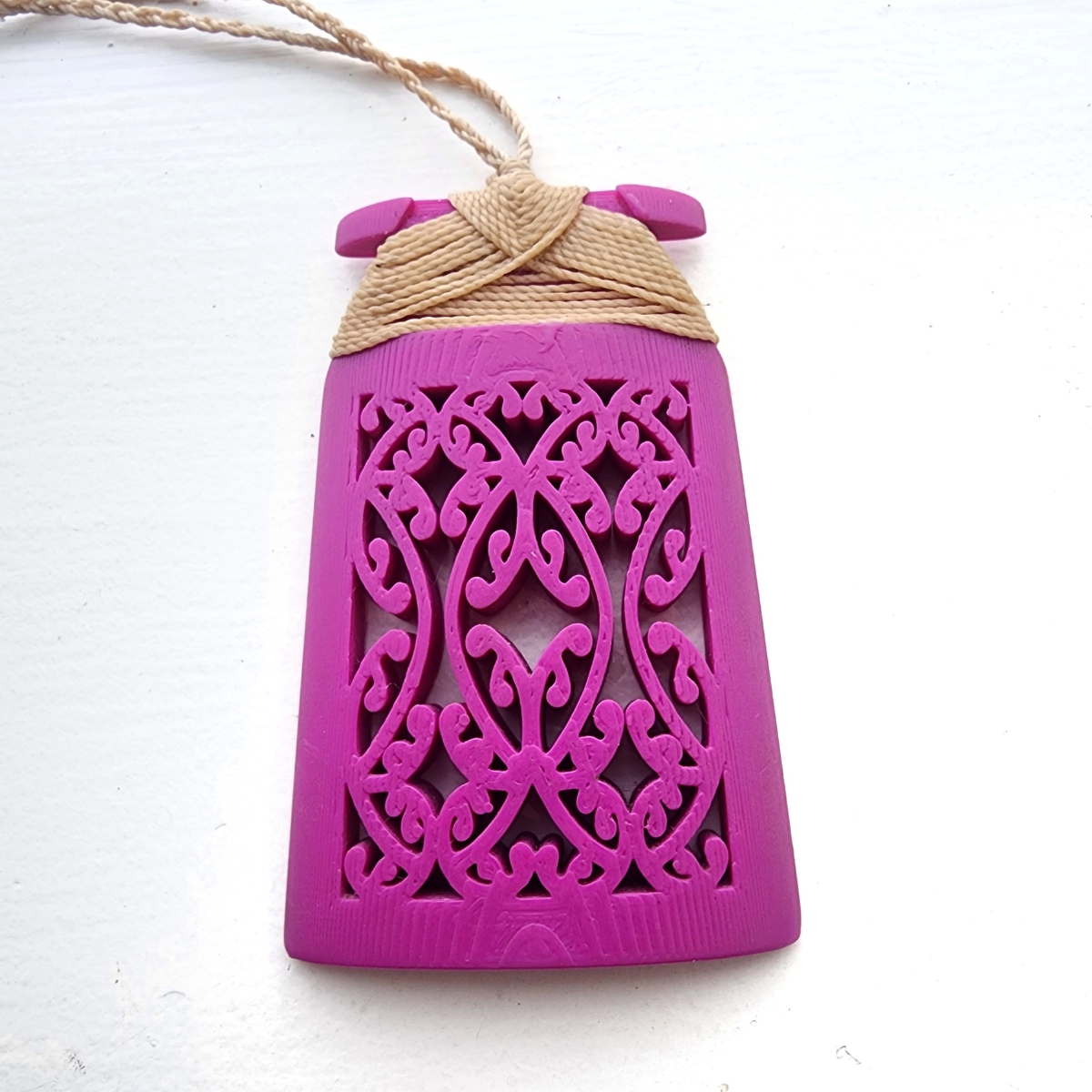 purple magenta toki necklace with traditional binding on white background
