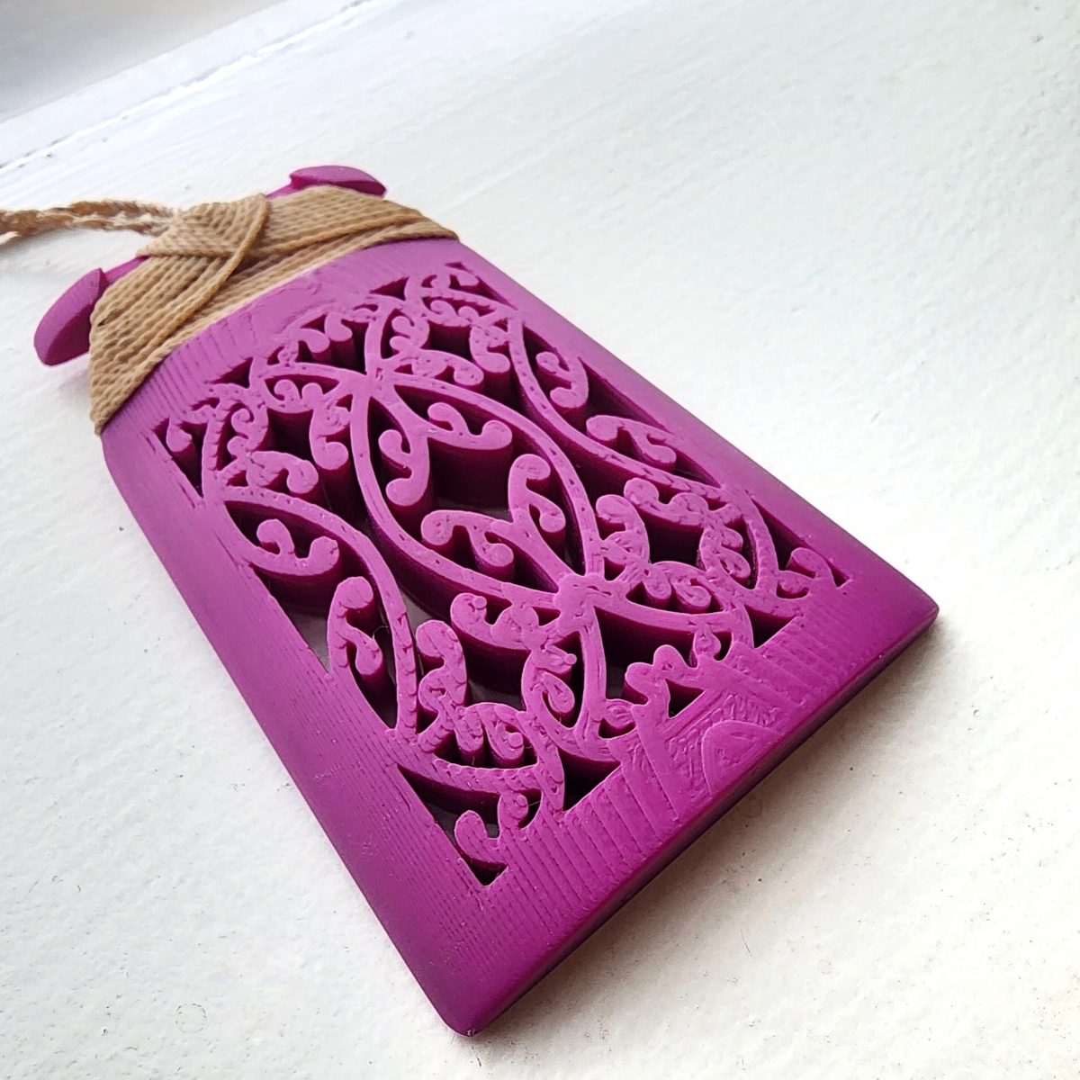 purple magenta toki necklace closeup of mangopare design on white background