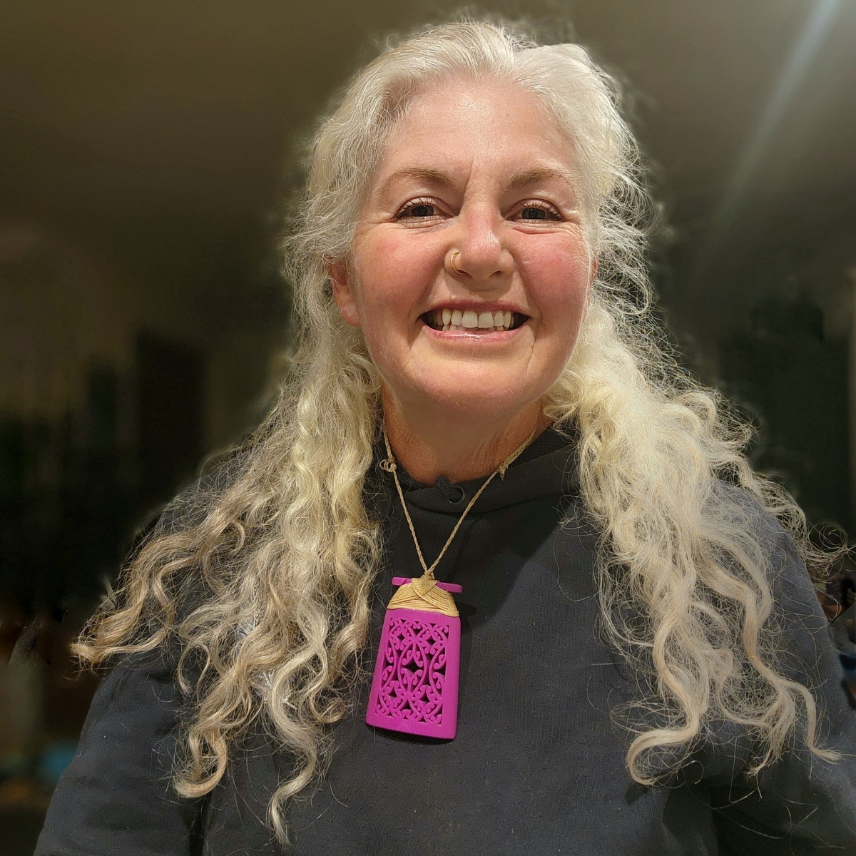 Purple magenta toki necklace on smiling model with white hair